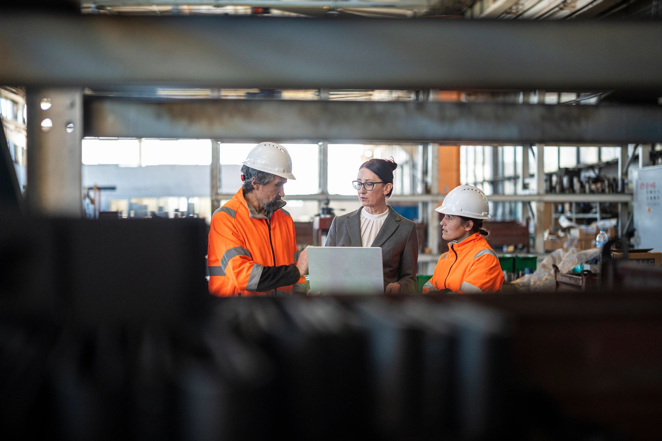 Engineering professionals collaborating in an industrial setting